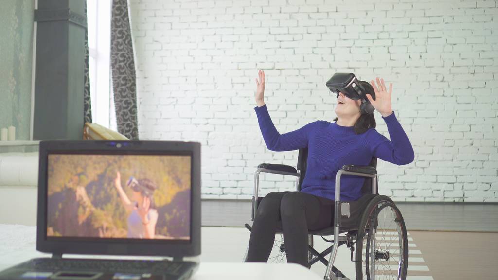 Adult woman playing VR in a wheelchair